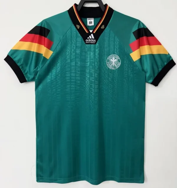 Germany national football team away jersey in teal green, with Adidas logo and crest on the chest, hanging on a hanger.