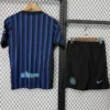Blue and black vertical striped soccer jersey on a hanger beside black shorts with a light blue swoosh logo and Inter crest on a metal rack display.