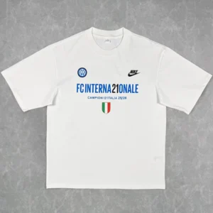 White T-shirt featuring Inter Milan logos: blue 'FC INTERNAZIONALE' text, 'Campioni d'Italia 25/26' line, Nike logo, Inter crest, and a small Italian flag shield.