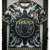 Black Versace T-shirt with Medusa emblem, gold logo, ornate white scrollwork, Italian flag crest, and Greek key trim.