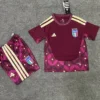 Italy national team maroon training jersey and matching shorts laid flat on a concrete surface with Adidas logo and crest visible.