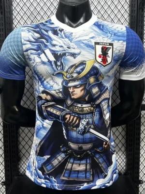 T-shirt with a blue-and-white dragon and armored samurai wielding a sword, plus a Japan JFA crest on the chest, on a rack background.