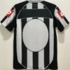 Juventus 2002/03 Retro Home Jersey Fan Version - Back View Back view of a black-and-white striped soccer jersey with a large white circle centered on the back and red logo accents on the sleeves.