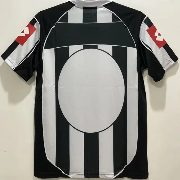 Juventus 2002/03 Retro Home Jersey Fan Version - Back View Back view of a black-and-white striped soccer jersey with a large white circle centered on the back and red logo accents on the sleeves.