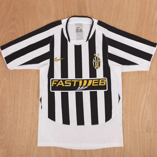 Juventus football jersey with black and white vertical stripes, sponsor logo FASTWEB, Nike crest, and team badge with two gold stars on the chest.