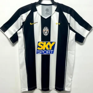Juventus 2004/05 Retro Home Jersey Fan Version - Front View Juventus football jersey on a hanger with black and white vertical stripes, a yellow Nike swoosh, club crest, two gold stars, and a SKY SPORT sponsor logo in the center.