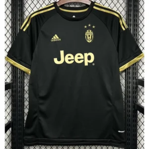Black Juventus football jersey with gold accents hanging on a hanger, displaying the Jeep sponsor in gold, Adidas logo, club crest with stars, and gold shoulder stripes.