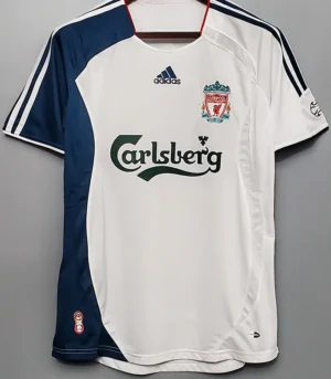 Liverpool 2006/07 Retro Away Jersey Fan Version - Front View Liverpool FC away jersey hanging on a hanger: white with navy panels, Carlsberg sponsor, Adidas logo, and Liverpool crest visible on the chest