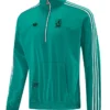 Teal Adidas track jacket with white stripes on sleeves, half-zip collar, and front pocket; features club crest on chest and small Adidas logo.