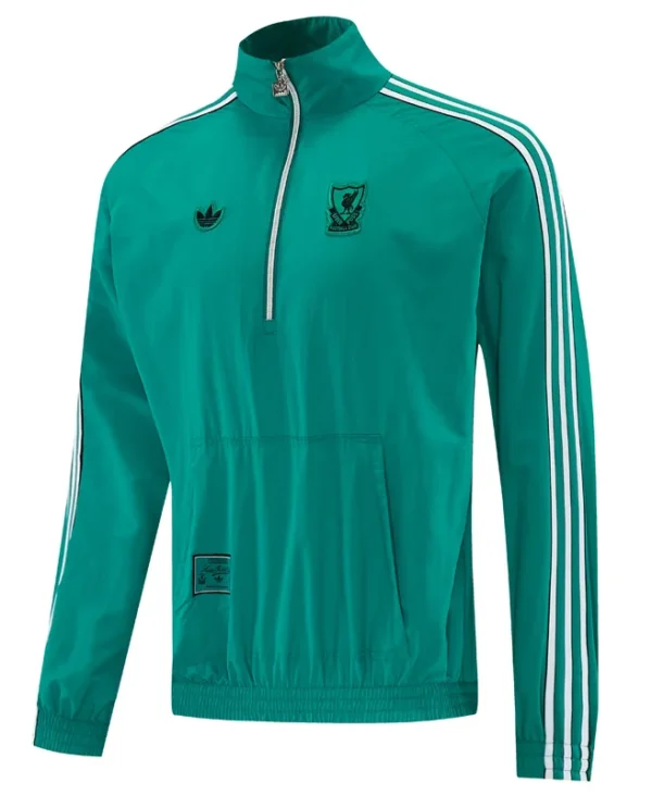 Teal Adidas track jacket with white stripes on sleeves, half-zip collar, and front pocket; features club crest on chest and small Adidas logo.