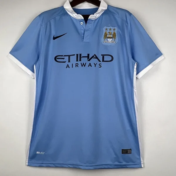 Light blue Manchester City home jersey on a hanger, featuring Nike swoosh and club crest with Etihad Airways sponsor.
