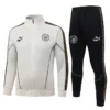 Manchester City 2026/27 Jacket Tracksuit - Front View White Manchester City track jacket with a full zipper and matching black track pants; both feature gold-trimmed side stripes, team crest, and Puma King branding.