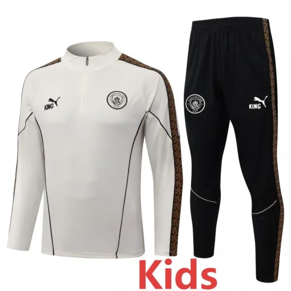 Kids' Manchester City training tracksuit: white top with crest and black pants with sidestrip detail and matching branding.
