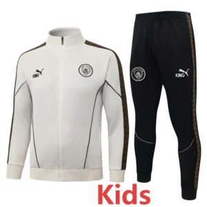 Kids' white and black tracksuit set with Manchester City logos, featuring a white zip jacket and black pants with decorative side stripes.