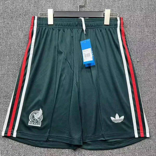 Dark green athletic shorts with red and white side stripes, featuring a Mexico emblem on the left leg and an Adidas trefoil on the right leg; blue tag attached.