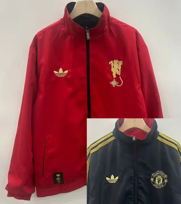 Manchester United 2025/26 Double Sided Windbreaker - Front View - KFCool – Football Jerseys & Soccer Kits Store Red zip-up jacket with gold crest on left chest and Adidas trefoil on the right, hanging on a wooden hanger.