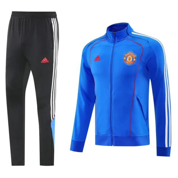Manchester United 2025/26 Blue Jacket Tracksuit - Front View - KFCool – Football Jerseys & Soccer Kits Store Black Adidas track pants with white side stripes paired with a blue Manchester United track jacket featuring red stitching and the club crest on the chest.