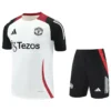 Manchester United 2025/26 White Black Training Short Suit - Front View Manchester United white away jersey with black sleeves and red trim, paired with black shorts featuring red side stripe and club crest, sponsor logo visible.