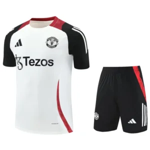 Manchester United white away jersey with black sleeves and red trim, paired with black shorts featuring red side stripe and club crest, sponsor logo visible.
