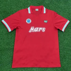 Napoli 1988/89 Retro Away Jersey Fan Version - Front View Red soccer polo shirt on grass with 'Mars' sponsor logo, left chest badge, and NR emblem.