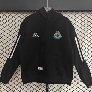 Newcastle United 2025/26 Hoody - Front View Black Adidas hoodie featuring a Newcastle United crest on the chest, white sleeve stripes, front pocket, hanging on a display against a grid backdrop.