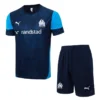 Olympique de Marseille training kit: navy jersey with light-blue sleeves, Randstad sponsor, Puma logo, and club crest; matching navy shorts with crest.