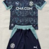 Dark blue camo soccer jersey with light teal trim and matching shorts laid flat, featuring CMA CGM sponsor and club crest.