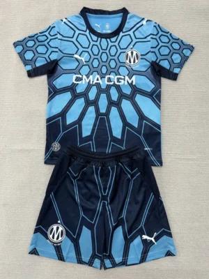 Marseille 2026/27 Goalkeeper Kids Kit Fan Version - Front View Blue geometric-pattern soccer jersey with matching shorts, Marseille logo, and CMA CGM sponsor text—team kit laid flat for display.