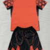 Marseille 2026/27 Goalkeeper Orange Kids Kit Fan Version - Back View Orange and black athletic jersey with matching geometric-pattern shorts laid flat, a sports set for training or games.