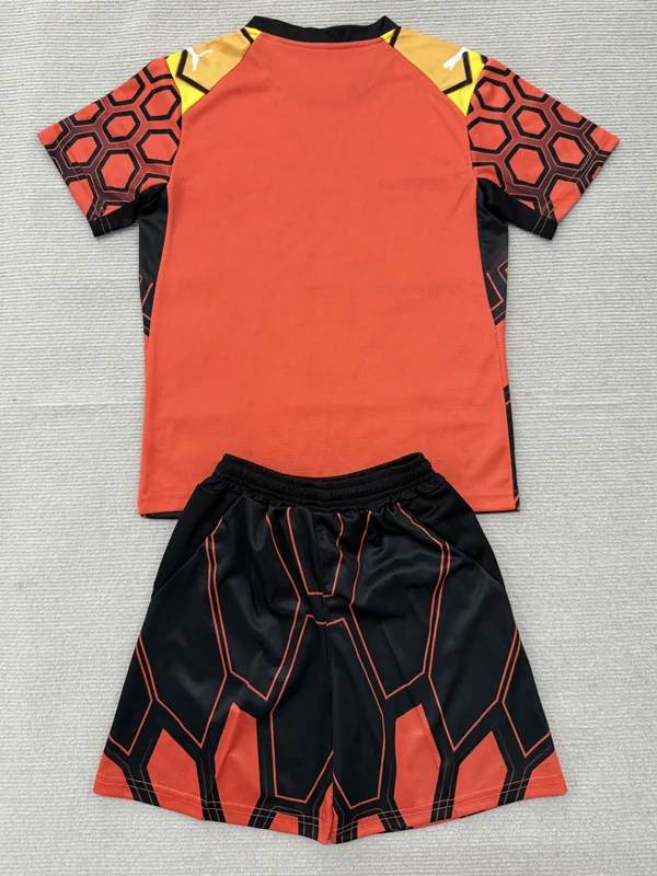Marseille 2026/27 Goalkeeper Orange Kids Kit Fan Version - Back View Orange and black athletic jersey with matching geometric-pattern shorts laid flat, a sports set for training or games.