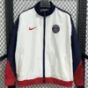 White Paris Saint-Germain jacket with navy sleeves and red cuffs, front zipper, and club crest on the chest.