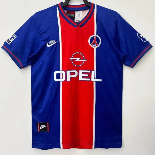 PSG 1995/96 Retro Home Jersey Fan Version - Front View Blue soccer jersey with a central red stripe and white trim, featuring Opel sponsor logo and Nike swoosh.