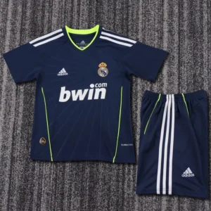 Navy Real Madrid football jersey with neon green trim and matching shorts on a textured surface, featuring bwin sponsor and Adidas logos