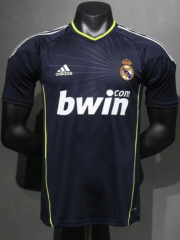 Real Madrid 2010/11 Retro Away Jersey Player Version - Front View Navy Real Madrid football jersey on a mannequin, with lime piping, Adidas logo, and bwin sponsor front and center.