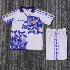 Real Madrid 1996/97 Retro Third Kids Kit Fan Version - Front View Real Madrid football kit: white shirt with purple geometric pattern, Real crest, Teka sponsor, and matching shorts with stripe and paw print accents.