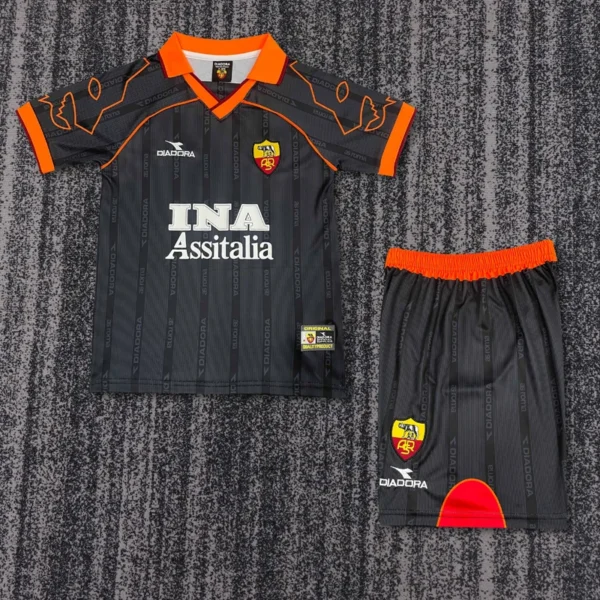 Roma 1999/00 Retro Away Kids Kit Fan Version - Front View - KFCool – Football Jerseys & Soccer Kits Store Adult-sized football kit laid flat: black pinstripe jersey with orange collar and cuffs, sponsor text 'INA Assitalia', and a crest; matching black shorts with an orange waistband and a red arc design.