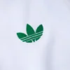 Senegal 2026/27 White Jacket Tracksuit - Model View - KFCool – Football Jerseys & Soccer Kits Store White fabric with an embroidered green Adidas trefoil logo on it.